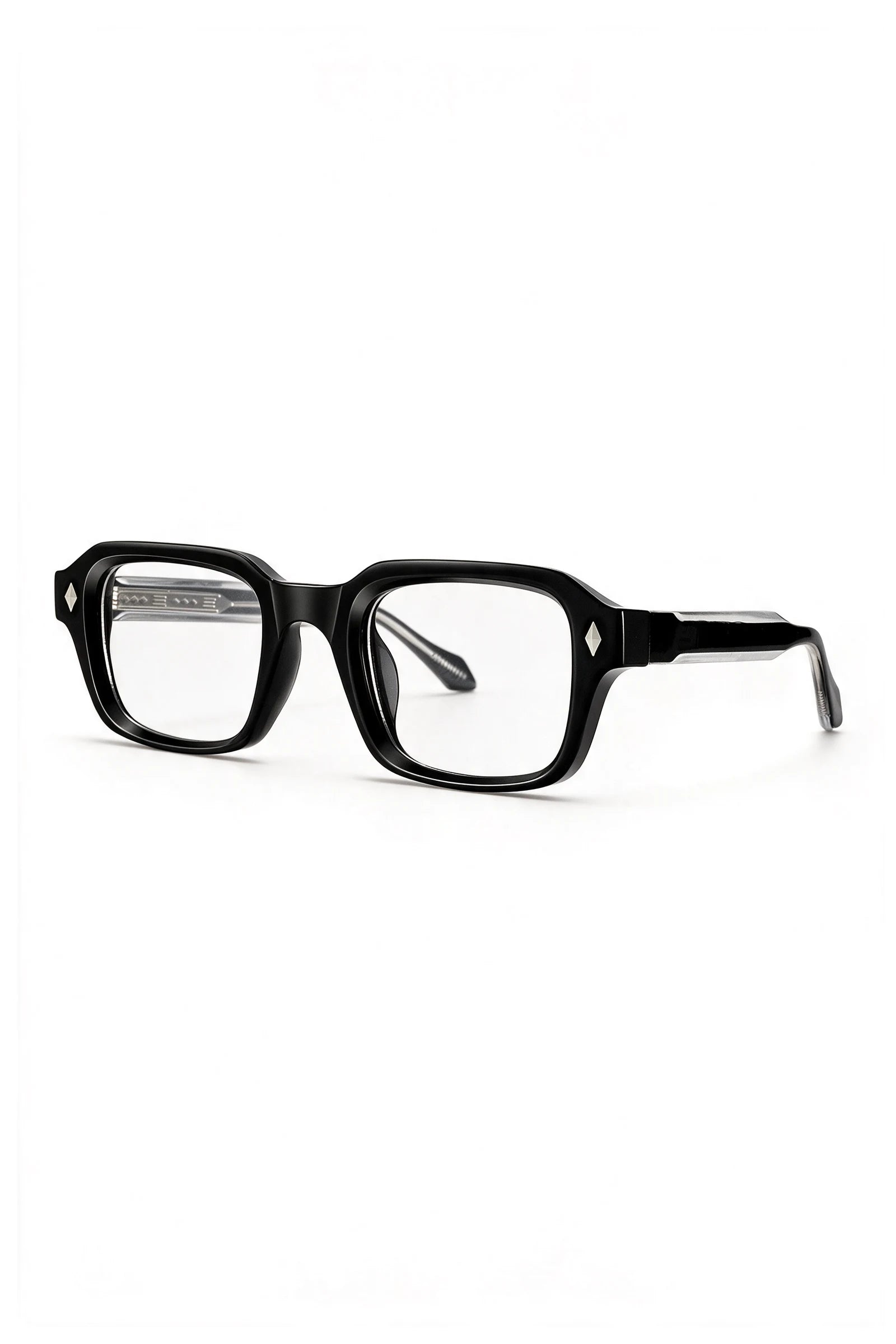 VELA Clear glasses three-quarter view showing the black-over-clear laminated temple and silver diamond stud