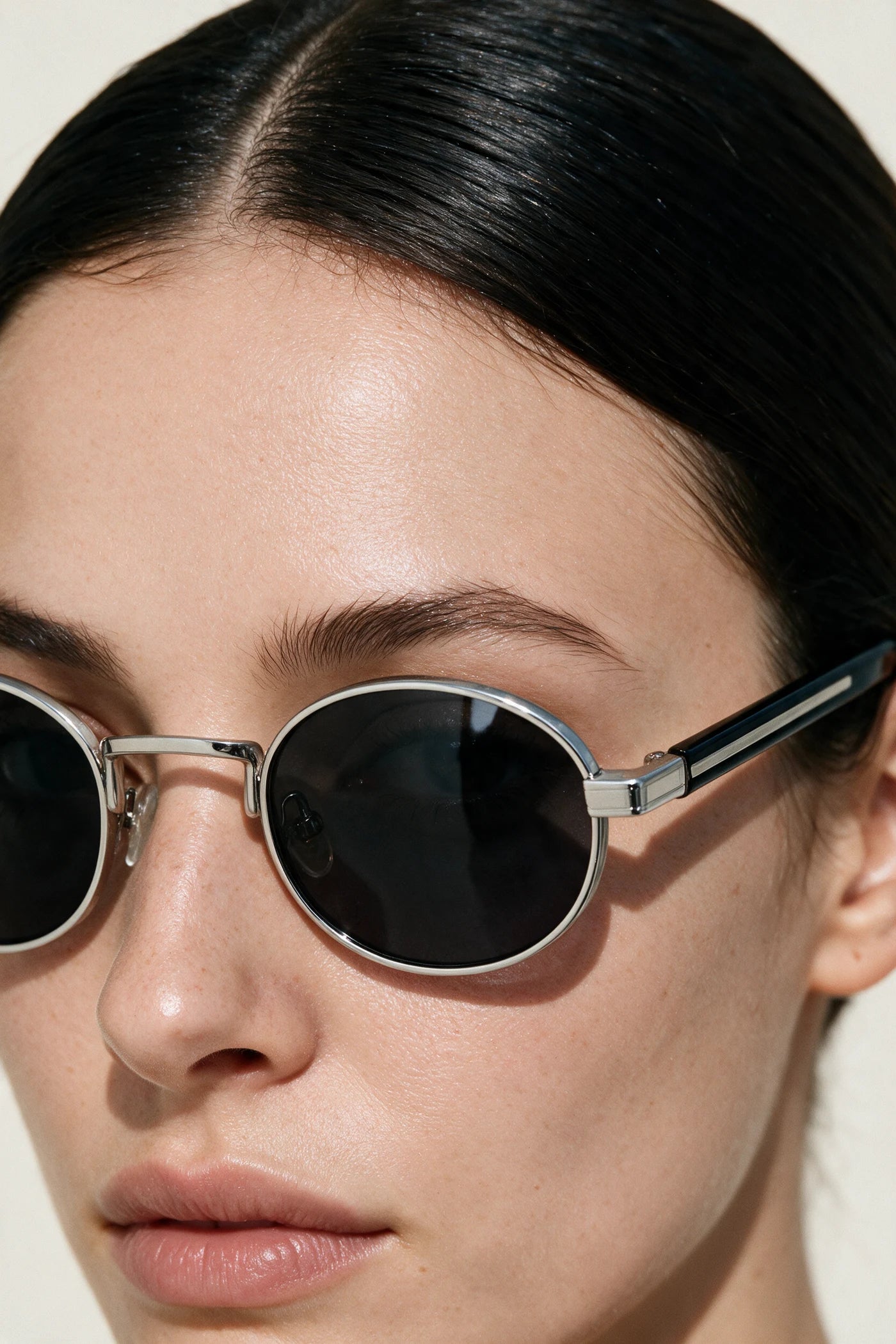 Close detail of the MARA silver rim, black temple with silver inlay and smoke lens