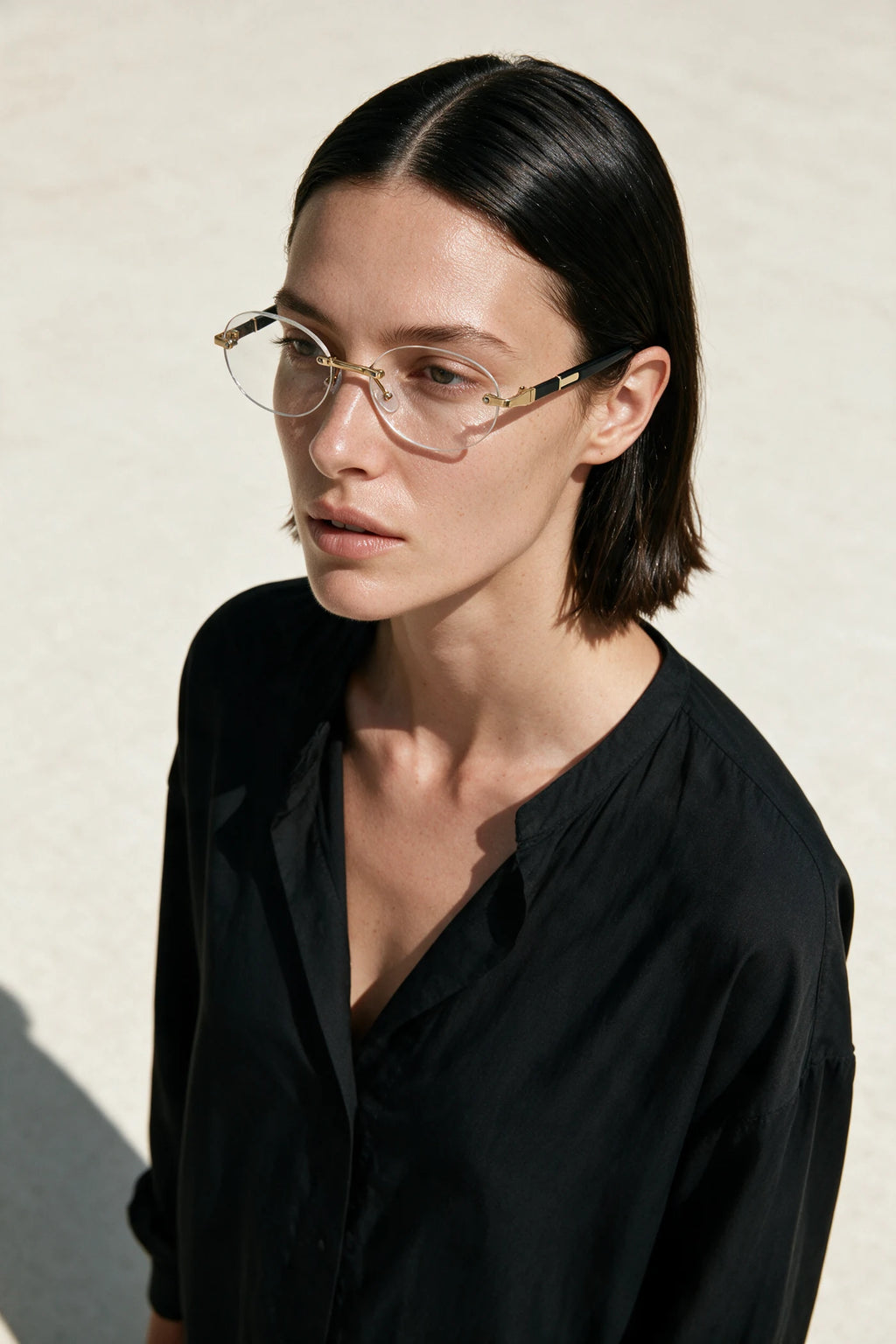 Woman wearing SERA rimless oval frames with clear lenses