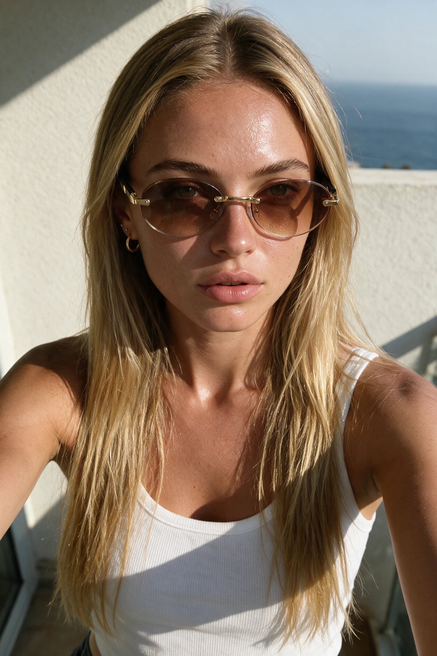 SERA rimless oval sunglasses in gradient tea worn outdoors in bright sunlight